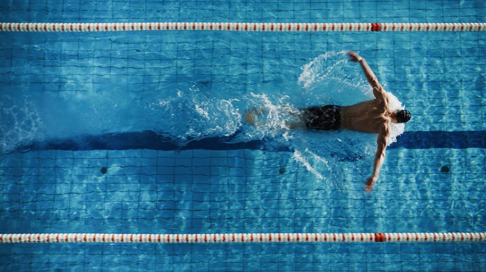 Swimmer using advanced French aquatic sports equipment in a swimming pool